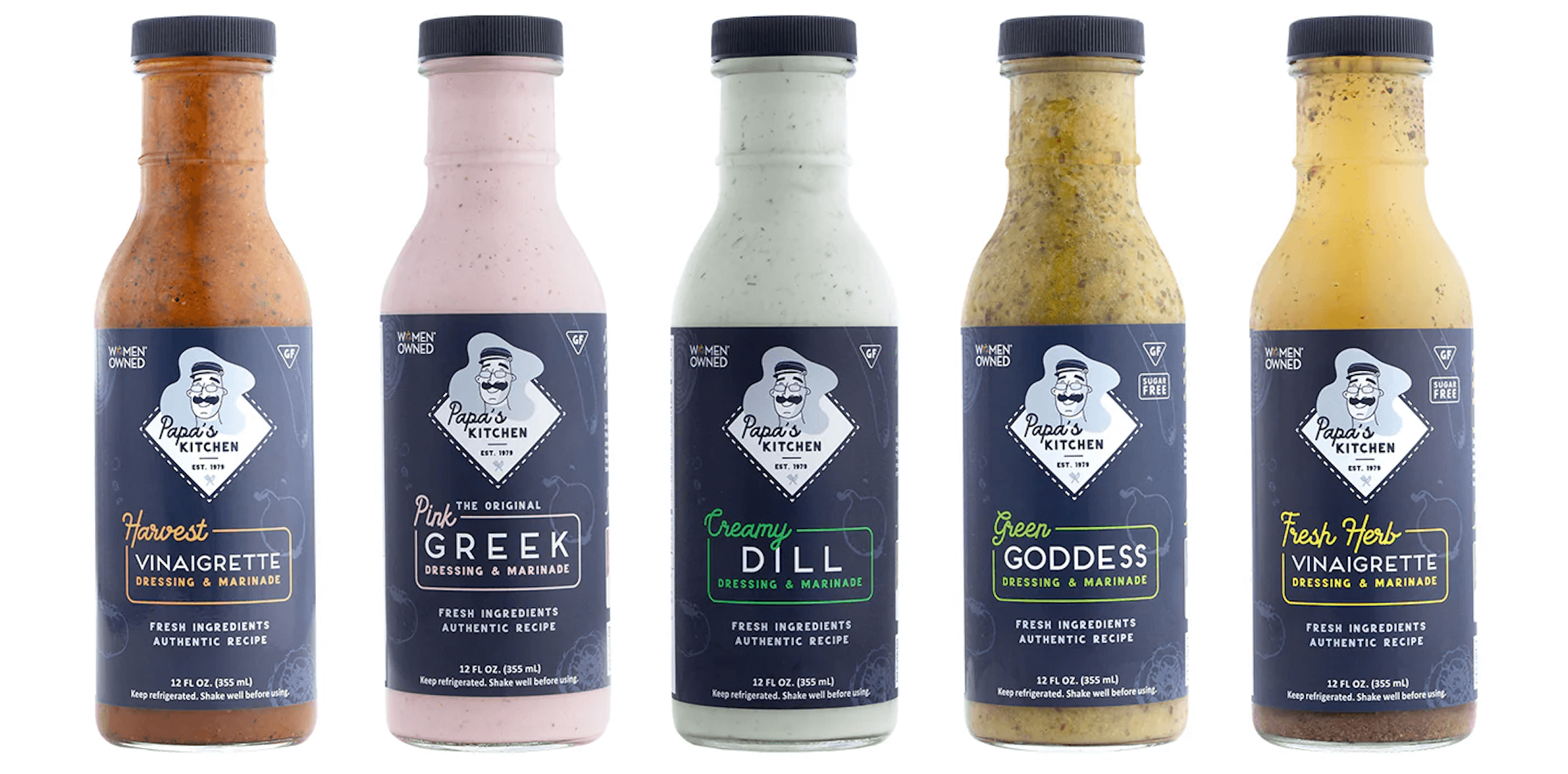 Five bottles of Papa’s Kitchen refrigerated dressings lined up, including Harvest Vinaigrette, Pink Greek™, Creamy Dill, Green Goddess, and Fresh Herb Vinaigrette.
