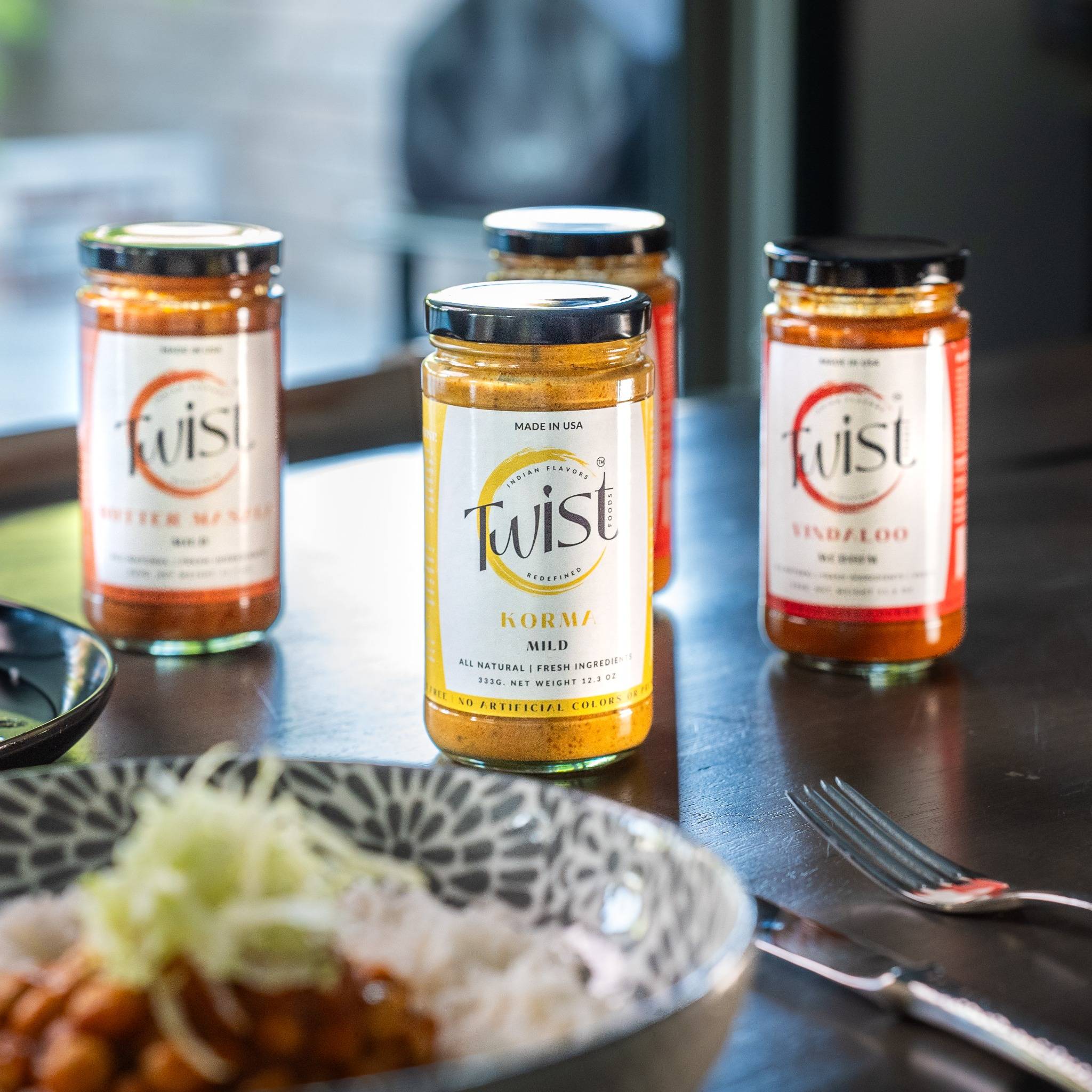 Twist Foods curry sauces and plated dishes highlighting restaurant-quality, clean ingredients.
