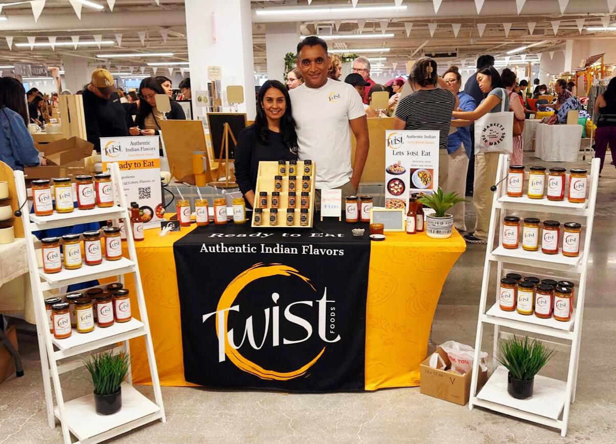 Twist Foods team presenting authentic Indian simmer sauces at a local market pop-up event.