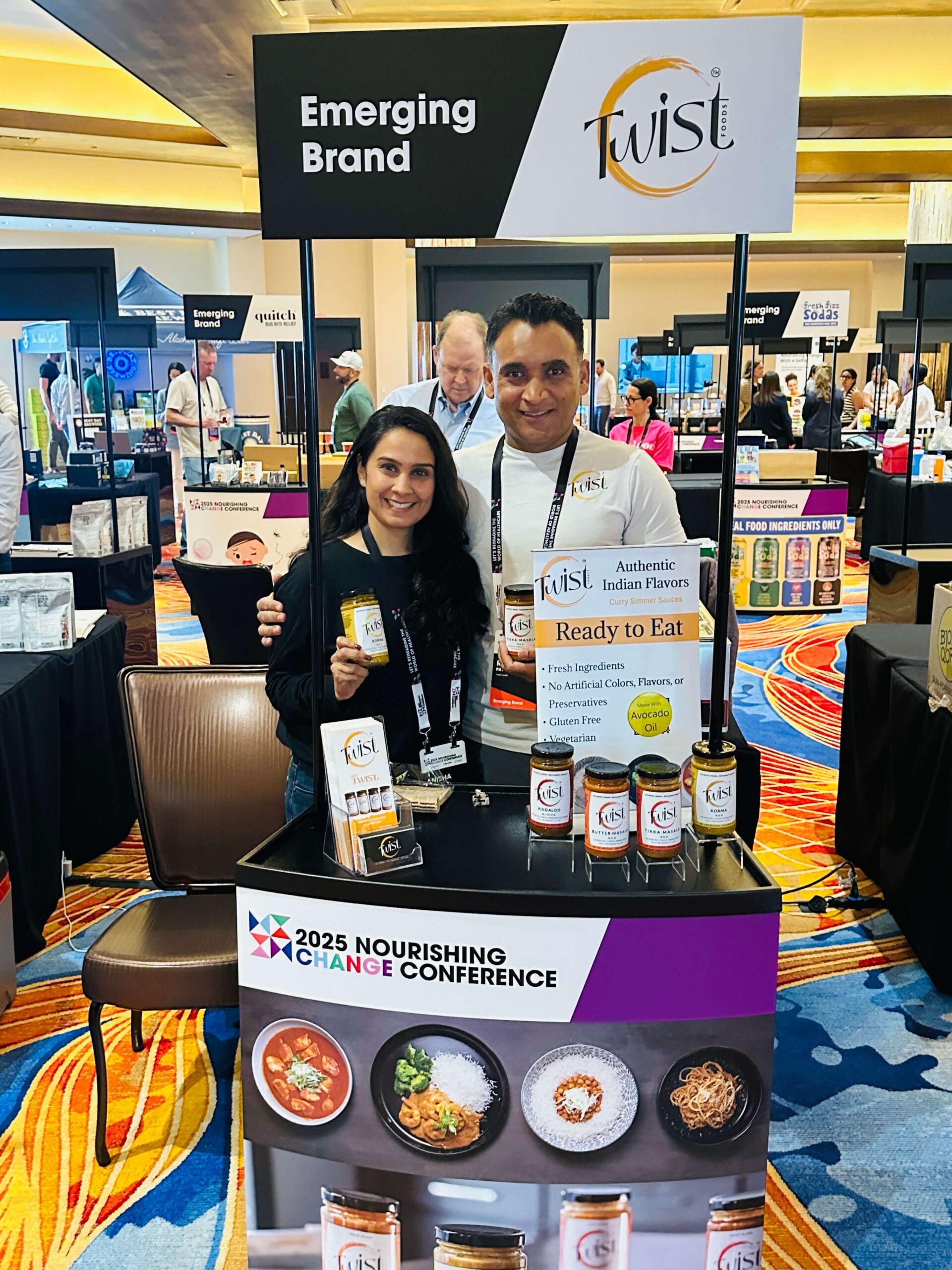 Twist Foods co-founders Anisha and Ritesh Patel at the Nourishing Change Conference Product Pavilion, showcasing their clean-label curry sauces.